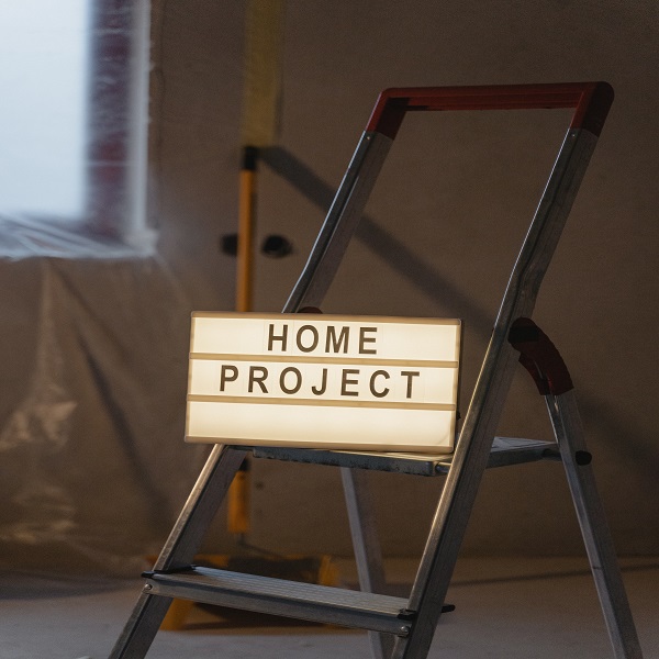 Home project lighted sign on top of ladder in a home